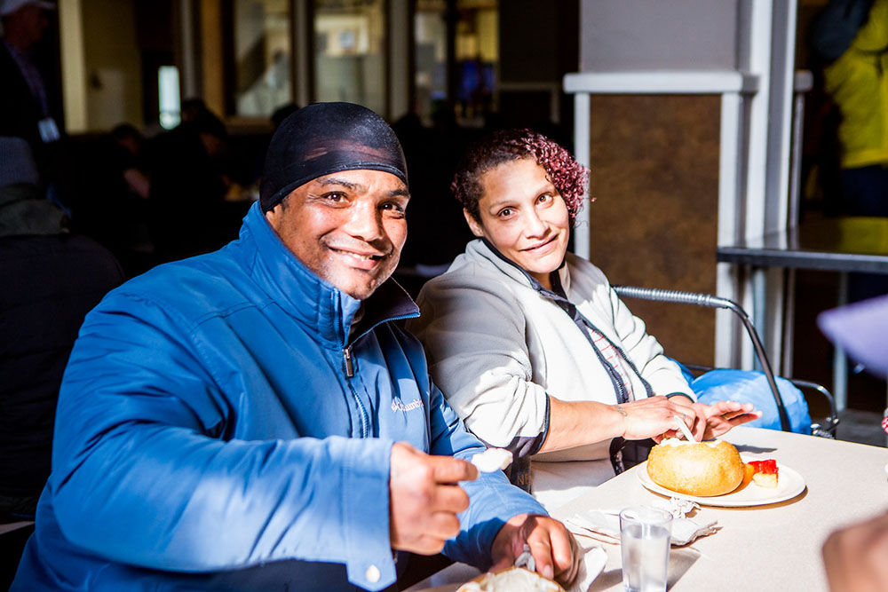 Enjoying a meal together on National Clam Chowder Day at the Mission