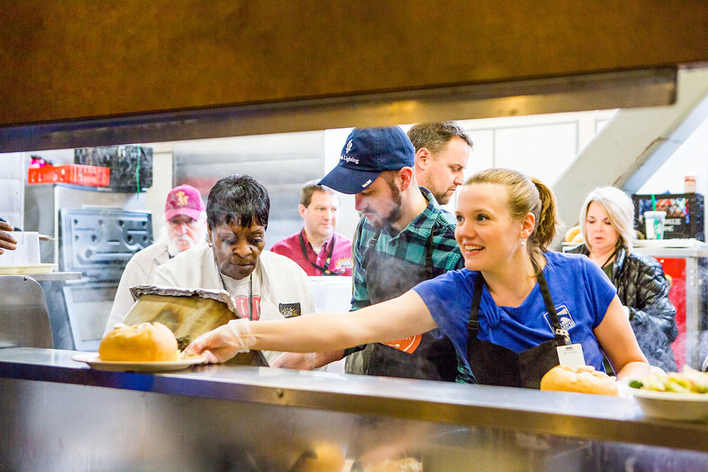 Volunteers serving chowder on National Chowder Day at Seattle's United Gospel Mission