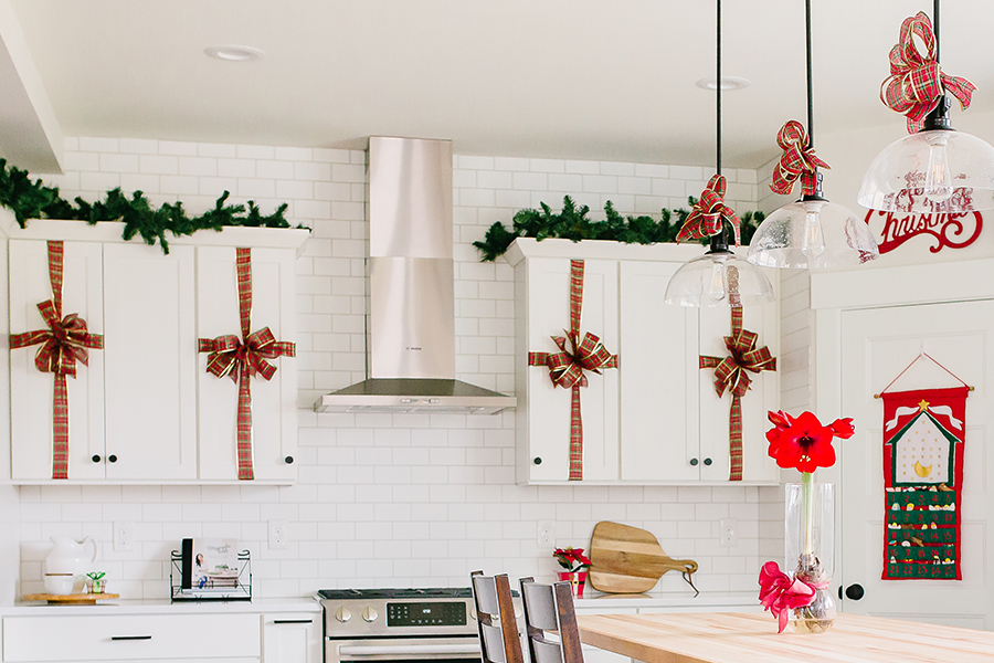 Heritage Market Kitchen Island Pendants Decorated with Red Bows for Christmas